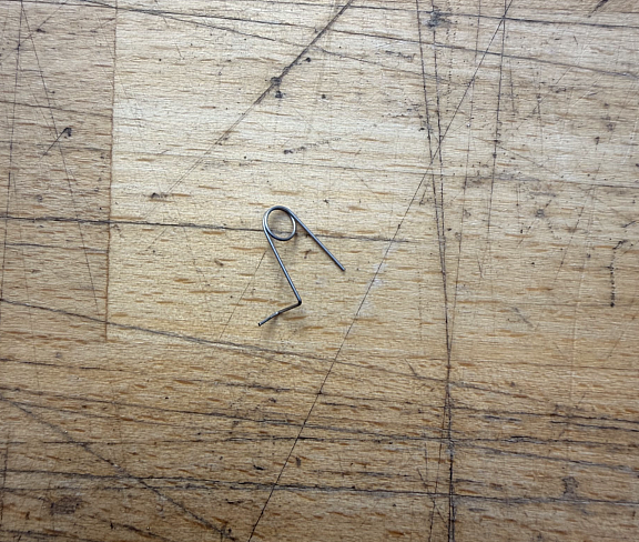 Anti reversal latch spring
